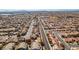 An aerial shot reveals a pleasant residential neighborhood with tidy homes, organized streets, and the city skyline visible at 4141 Coburn St, North Las Vegas, NV 89032