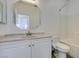 Bathroom featuring white vanity with neutral marble countertop, toilet with bidet feature and tub with white tile surround at 4141 Coburn St, North Las Vegas, NV 89032