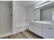This bright bathroom features double sinks, a shower, and a soaking tub at 4141 Coburn St, North Las Vegas, NV 89032