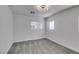 This bedroom features neutral carpet and a window with natural light at 4141 Coburn St, North Las Vegas, NV 89032
