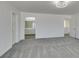 This bedroom has neutral carpet, a view to the bathroom, and two doorways at 4141 Coburn St, North Las Vegas, NV 89032