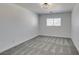 This bedroom has neutral carpet and a window with natural light at 4141 Coburn St, North Las Vegas, NV 89032