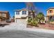 Charming two-story home with desert landscaping, neutral stucco, and two-car garage at 4141 Coburn St, North Las Vegas, NV 89032