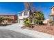 Inviting two-story home featuring a desert landscape and a spacious driveway at 4141 Coburn St, North Las Vegas, NV 89032