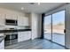 Modern kitchen showcasing stainless steel appliances and sliding glass doors to the backyard at 4141 Coburn St, North Las Vegas, NV 89032
