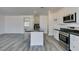 Modern kitchen design with granite counters, stainless steel appliances and light wood floors at 4141 Coburn St, North Las Vegas, NV 89032