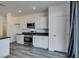 Well-equipped kitchen area featuring granite counters, stainless steel appliances and wood-look floors at 4141 Coburn St, North Las Vegas, NV 89032