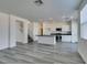 Spacious kitchen and living area with island, stainless appliances, and wood-style flooring at 4141 Coburn St, North Las Vegas, NV 89032