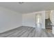 Bright living room with gray wood-look floors, white walls, and a staircase leading to the upper level at 4141 Coburn St, North Las Vegas, NV 89032