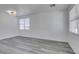 Bright, minimalist living room featuring stylish, light-toned wood-look flooring at 4141 Coburn St, North Las Vegas, NV 89032