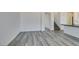 Open-concept living area with modern gray wood flooring and neutral wall colors at 4141 Coburn St, North Las Vegas, NV 89032
