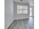 Bright living room featuring light wood-look flooring and a view of the front door at 4141 Coburn St, North Las Vegas, NV 89032