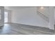 Bright living room features new gray hardwood flooring and a decorative glass front door at 4141 Coburn St, North Las Vegas, NV 89032