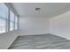 Bright living room featuring multiple windows and gray wood-look flooring at 4141 Coburn St, North Las Vegas, NV 89032