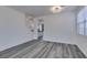 Spacious open floor plan featuring light wood-look flooring, with stairs and kitchen view at 4141 Coburn St, North Las Vegas, NV 89032