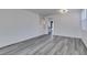 Open-concept living room with light wood-look flooring, and freshly painted walls at 4141 Coburn St, North Las Vegas, NV 89032