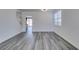 Bright and airy living room with modern gray wood-look floors and white walls at 4141 Coburn St, North Las Vegas, NV 89032