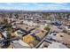 This aerial view features houses with pools, mature trees, and a spacious backyard surrounded by lush greenery at 4258 E Twain Ave, Las Vegas, NV 89121