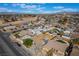 An aerial view captures a neighborhood with pools, solar panels and a beautiful mountain range in the background at 4258 E Twain Ave, Las Vegas, NV 89121