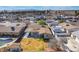 A cozy backyard with a covered patio, storage shed, and verdant green grass surrounded by a tall wooden privacy fence at 4258 E Twain Ave, Las Vegas, NV 89121