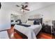Well-lit bedroom boasts a large mirror closet, hardwood floors, and a ceiling fan at 4258 E Twain Ave, Las Vegas, NV 89121