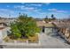Inviting home showcasing a well-kept yard, mature tree, and a two-car garage at 4258 E Twain Ave, Las Vegas, NV 89121