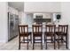 Bright kitchen showcases stainless steel refrigerator, barstool seating, and sleek design, enhancing the home's appeal at 4258 E Twain Ave, Las Vegas, NV 89121