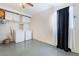 Functional laundry area with washer, dryer, overhead storage, and natural light at 4258 E Twain Ave, Las Vegas, NV 89121