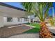 Charming backyard featuring a covered patio and lush landscaping at 4804 El Tesoro Ave, Las Vegas, NV 89121