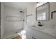 Modern bathroom with black fixtures, stylish shower and toilet with white marble countertops at 4804 El Tesoro Ave, Las Vegas, NV 89121