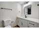 Modern bathroom with white vanity, black fixtures, framed mirror, and wood flooring at 4804 El Tesoro Ave, Las Vegas, NV 89121