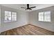 Light-filled bedroom with two windows and wood-look floors at 4804 El Tesoro Ave, Las Vegas, NV 89121