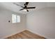 A bright bedroom featuring wood-look flooring, ceiling fan, and a window at 4804 El Tesoro Ave, Las Vegas, NV 89121