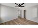 Bright bedroom featuring wood-look floors, a modern ceiling fan, and a large closet at 4804 El Tesoro Ave, Las Vegas, NV 89121