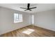 Bright bedroom with wood floors, a ceiling fan, large window, and fresh paint at 4804 El Tesoro Ave, Las Vegas, NV 89121