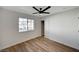 Cozy bedroom with wood-look floors, a window, and closet at 4804 El Tesoro Ave, Las Vegas, NV 89121