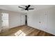 Spacious bedroom with wood floors, three doors, and natural light at 4804 El Tesoro Ave, Las Vegas, NV 89121