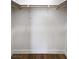 Walk-in closet with a shelf and a wooden pole for hanging clothes and wood flooring at 4804 El Tesoro Ave, Las Vegas, NV 89121