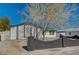 Single-story home with well-maintained front yard, brick wall, and mature tree at 4804 El Tesoro Ave, Las Vegas, NV 89121