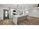 Bright kitchen featuring a large island with seating, stainless steel appliances, and a stylish front door at 4804 El Tesoro Ave, Las Vegas, NV 89121