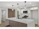 An open kitchen featuring a large island with stylish wooden accents and modern fixtures at 4804 El Tesoro Ave, Las Vegas, NV 89121