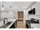 Modern kitchen with stainless steel appliances, island sink, and sleek countertops at 4804 El Tesoro Ave, Las Vegas, NV 89121