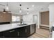 Spacious kitchen featuring stainless steel appliances, island with sink, and modern lighting at 4804 El Tesoro Ave, Las Vegas, NV 89121