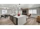 Open-concept kitchen and dining area with modern island, seating, and lighting at 4804 El Tesoro Ave, Las Vegas, NV 89121