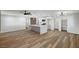 Spacious living room with modern island, updated appliances, wood floors, and a ceiling fan at 4804 El Tesoro Ave, Las Vegas, NV 89121
