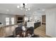 An open-concept living space with modern lighting, a fireplace, and a sleek kitchen island at 4804 El Tesoro Ave, Las Vegas, NV 89121