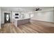 An open-concept living space with modern lighting, a kitchen island, and wood flooring at 4804 El Tesoro Ave, Las Vegas, NV 89121