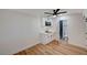 An airy room featuring wood-look flooring, modern kitchenette, and an adjacent tiled bathroom at 4804 El Tesoro Ave, Las Vegas, NV 89121