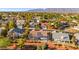 An aerial view of a suburban neighborhood with single-Gathering homes and mature trees with mountain views at 5009 Elm Grove Dr, Las Vegas, NV 89130