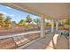 View from covered patio with stately columns overlooking the gravel yard at 5009 Elm Grove Dr, Las Vegas, NV 89130